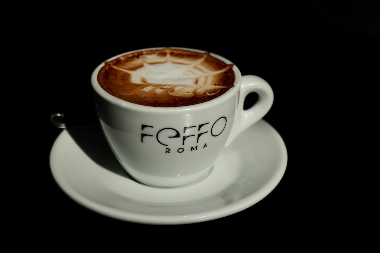 Close-up of a cappuccino with intricate latte art in a Rome café. Ideal stock photo for coffee enthusiasts.